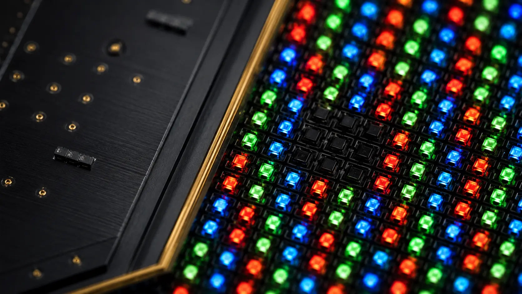 Magnified concept visualization of independently glowing red, green and blue MicroLED emitters beside fully switched-off pixels